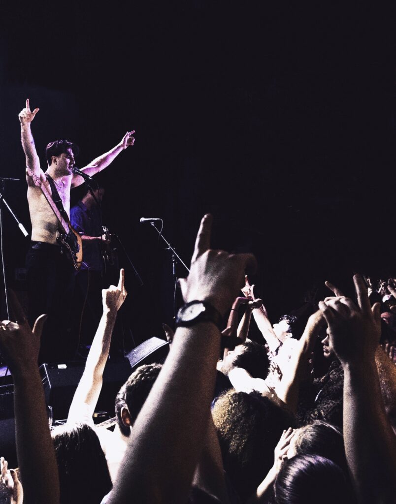 The lead singer of The Fat Stacks being cheered on during a live performance.