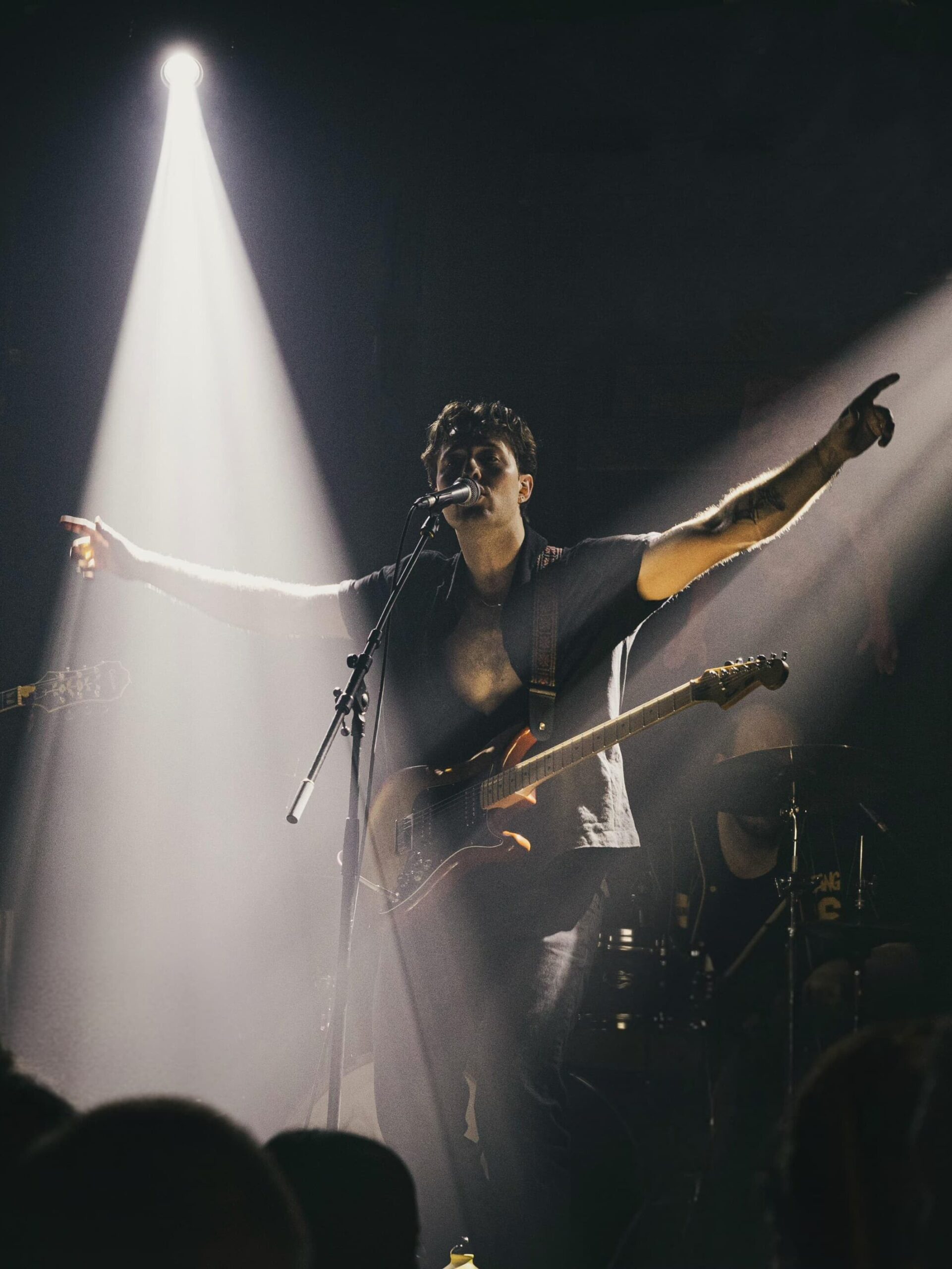 The Fat Stacks performing live, with the lead singer facing the crowd.